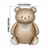 A soft brown foil balloon shaped like a teddy bear with white accents and a pink bow.