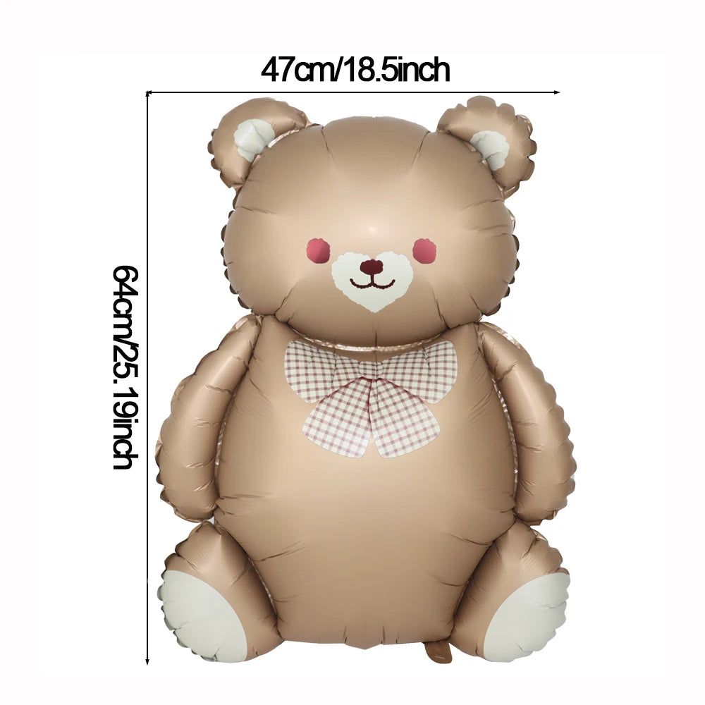A soft brown foil balloon shaped like a teddy bear with white accents and a pink bow.