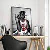A framed canvas print of a basketball player in a red and white jersey looking towards the camera.