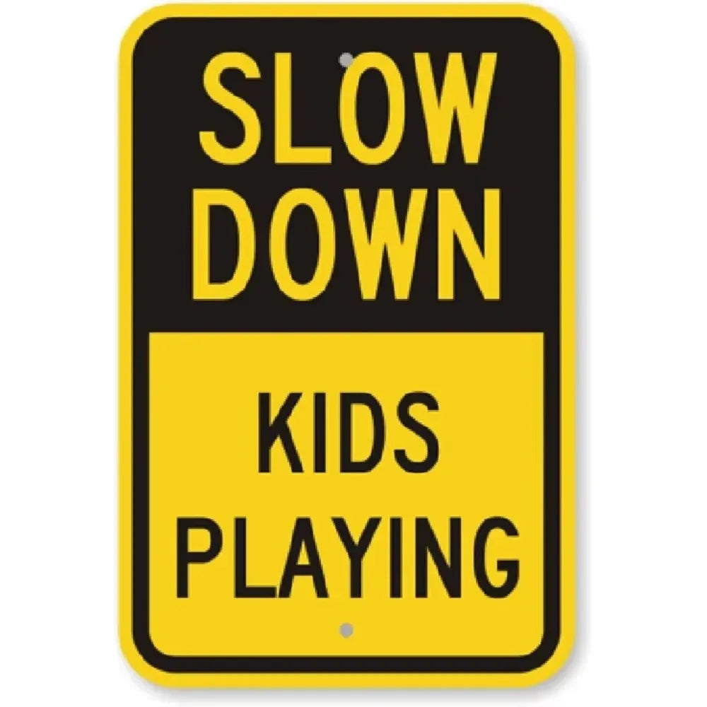A yellow and black sign with text that reads SLOW DOWN and KIDS PLAYING.