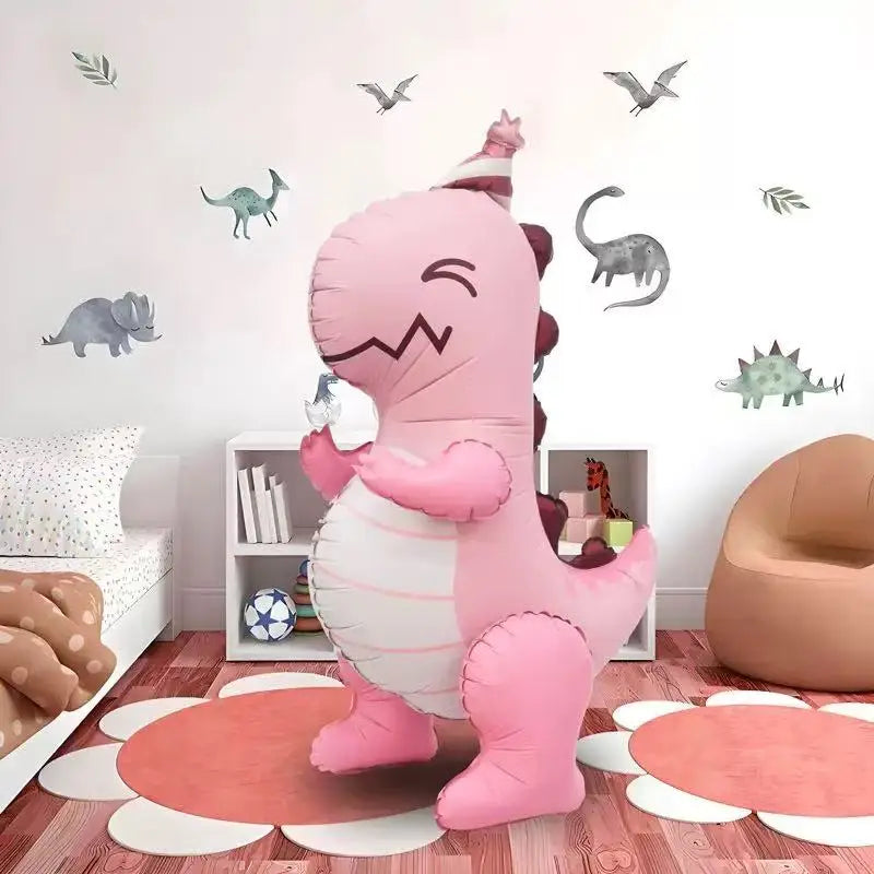 A pink inflatable dinosaur toy standing on a wooden floor with various decorative elements.