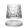 A clear crystal whiskey glass with a textured relief design and matching coaster.