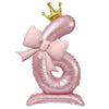 A pink foil balloon shaped like the number 3, topped with a gold crown.