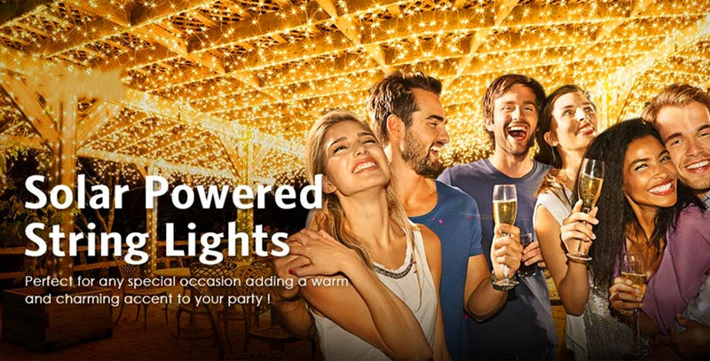 A group of friends enjoying an outdoor party illuminated by warm solar-powered string lights.