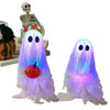 A set of glowing purple and blue Halloween ghost decorations, including a skull figure.