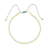 Handmade boho glass bead bracelet with adjustable cord in pale green and gold beads