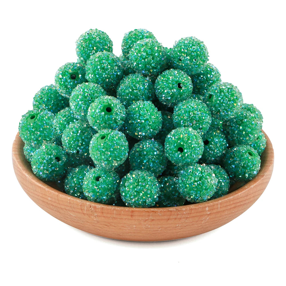 A pile of bright green textured resin beads for jewelry making in a wooden bowl.