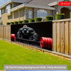 A black gorilla lifting a red barbell against a backdrop of a modern house and wooden fence.