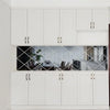 White kitchen cabinets with a diamond-patterned glass display and white drawers.