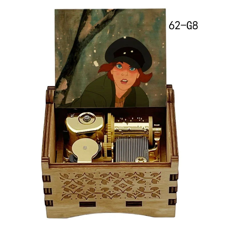 A wooden music box featuring a portrait of a woman in a dark hat and green coat, with brass and wooden components visible ins