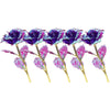 A spray of artificial crystal flowers in shades of purple and pink with gold stems.