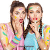 Two women display glow-in-the-dark silicone bracelets on their arms with colorful face paint.