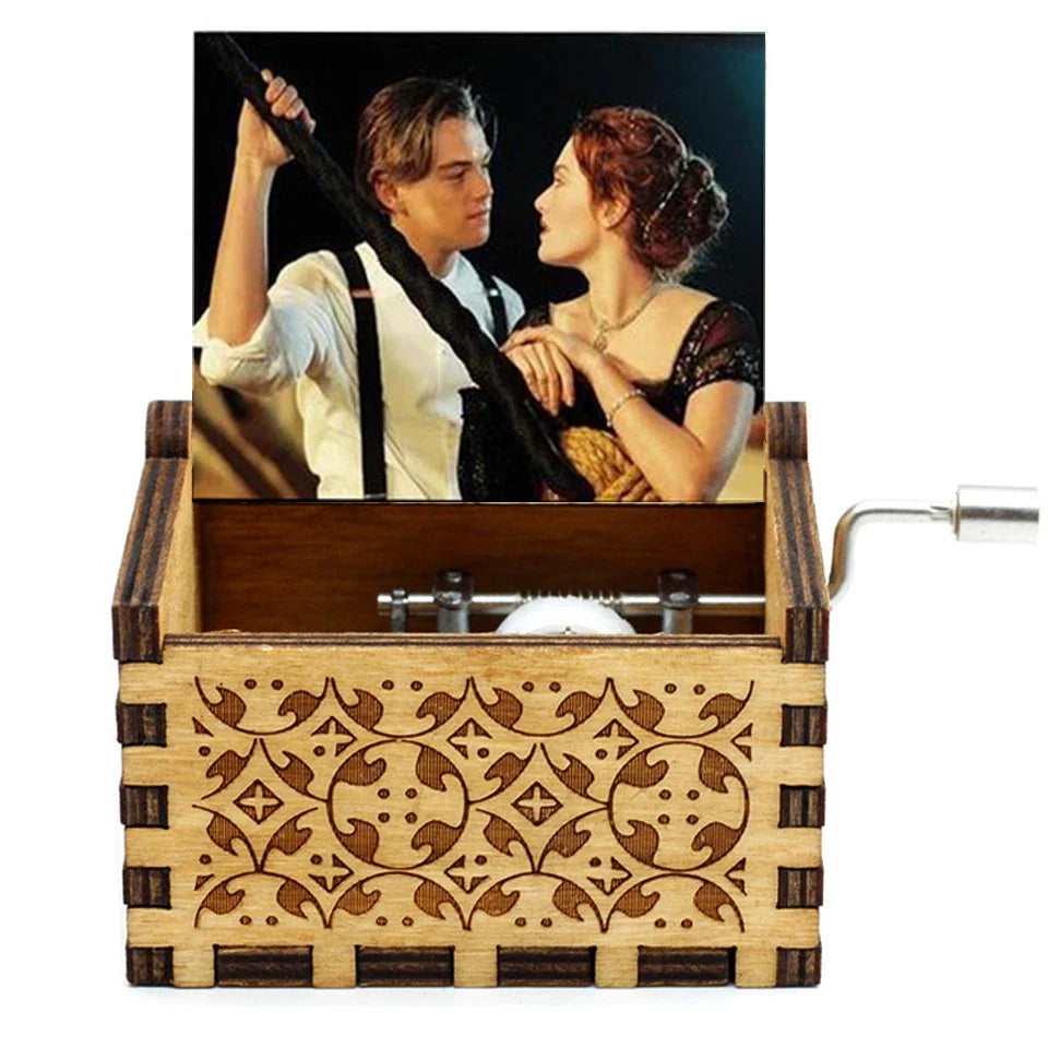 A carved wooden music box featuring a scene of two people looking at each other.
