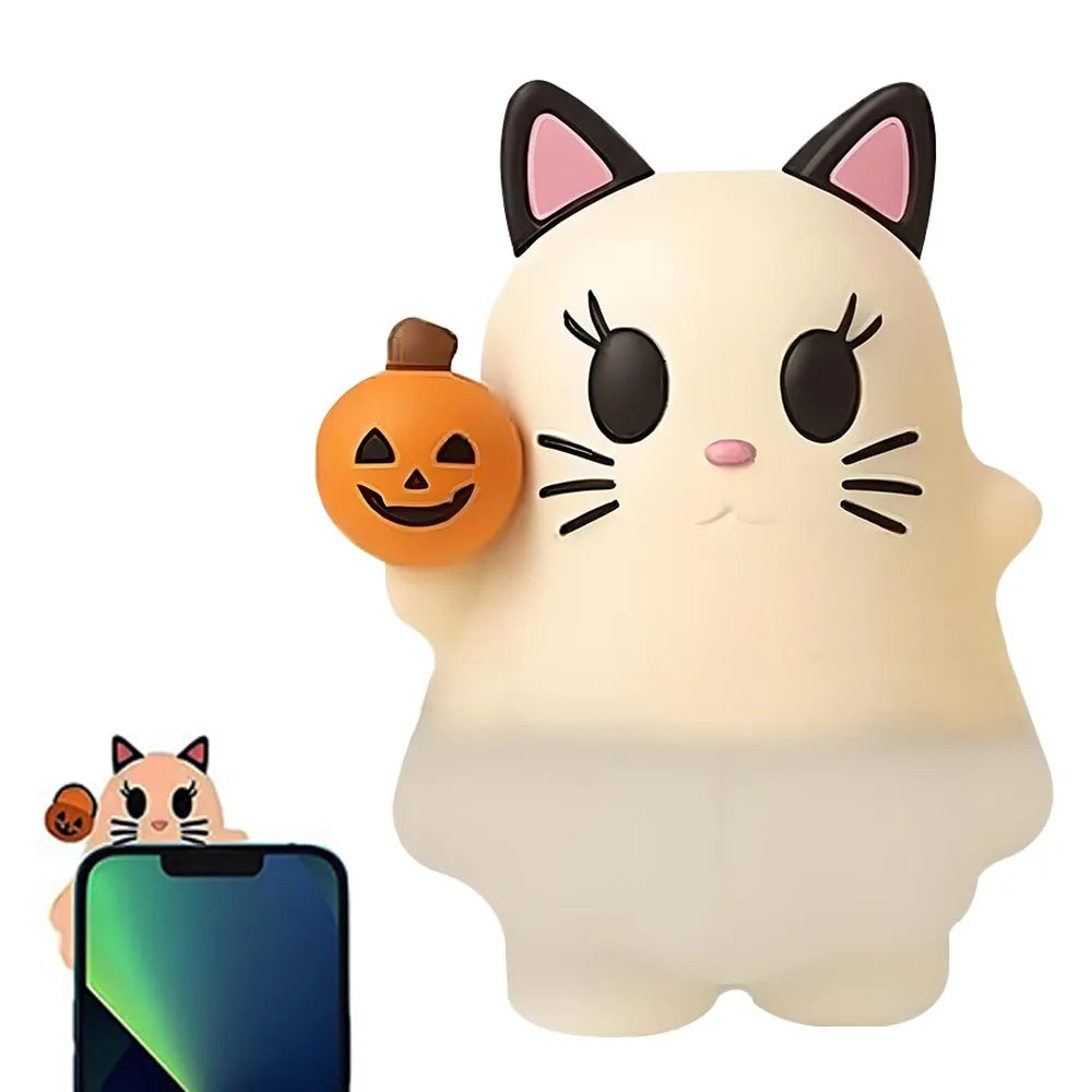 A white cat-shaped ghost phone decoration charm with black ears and a carved pumpkin detail.