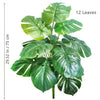 A vibrant artificial Monstera plant with twelve large silk green leaves.