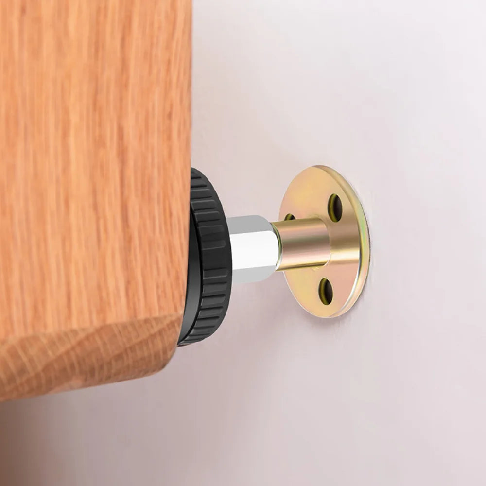A brass adjustable bed stabilizer is mounted on a wooden cabinet with a black adjustment knob.