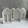 White silicone molds shaped like gothic church windows for crafting