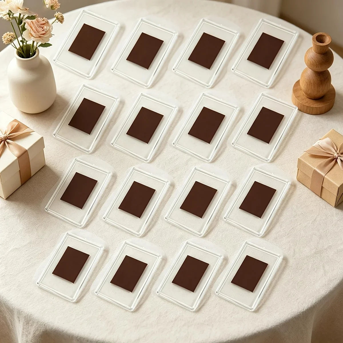 A collection of square photo frame magnets in various shades of brown arranged on a white tablecloth.