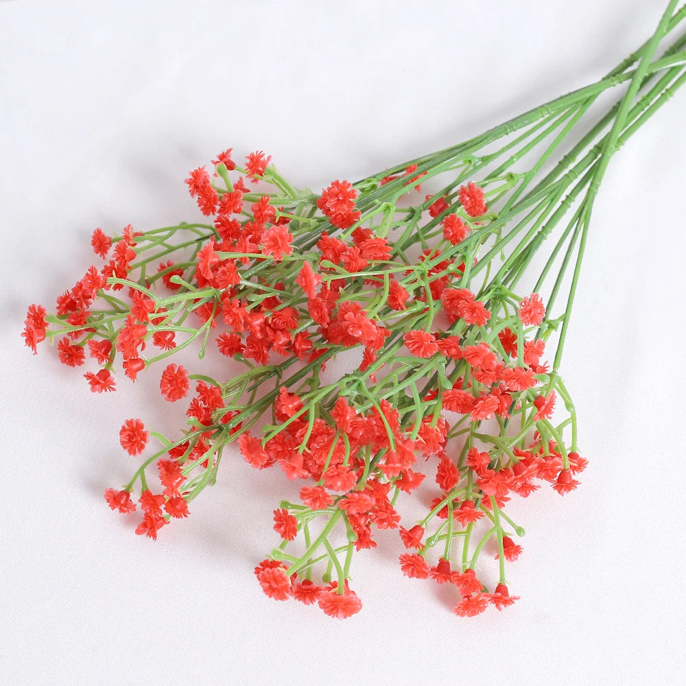 A spray of bright orange-red artificial baby's breath flowers on green stems.