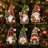 A set of three Christmas diamond art ornaments featuring Santa, a snowman, and a reindeer pendant hanging on a green fir tree