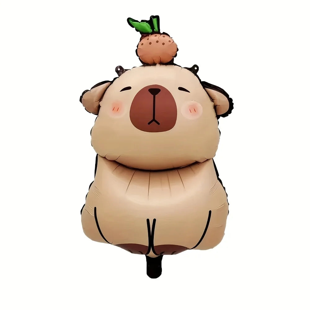 A plush capybara decoration set featuring a foil balloon and banner for a birthday party.