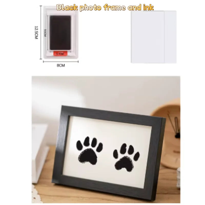 A black photo frame displaying two paw prints on a white background.