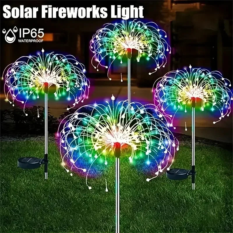 A display of colorful, light-up fireworks from a solar light product in a garden setting.