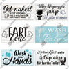 A collection of rustic wooden wall signs with humorous messages about nudity, farting, and handwashing.