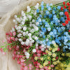 A bouquet of artificial baby's breath flowers in various shades of white, blue, pink, and red.