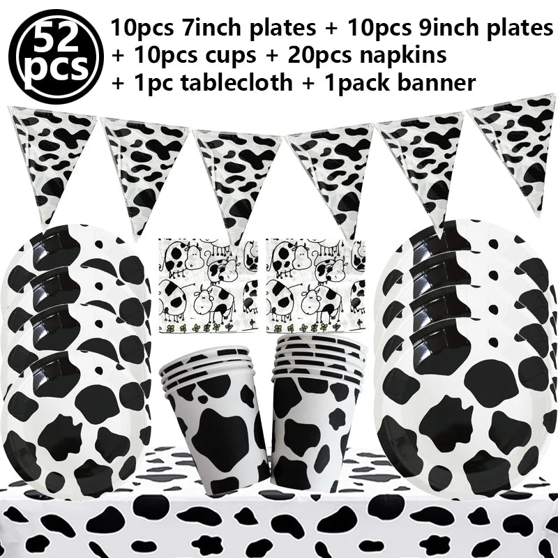 A collection of cow print tableware including plates, cups, napkins, a tablecloth, and a banner for a farm-themed party.