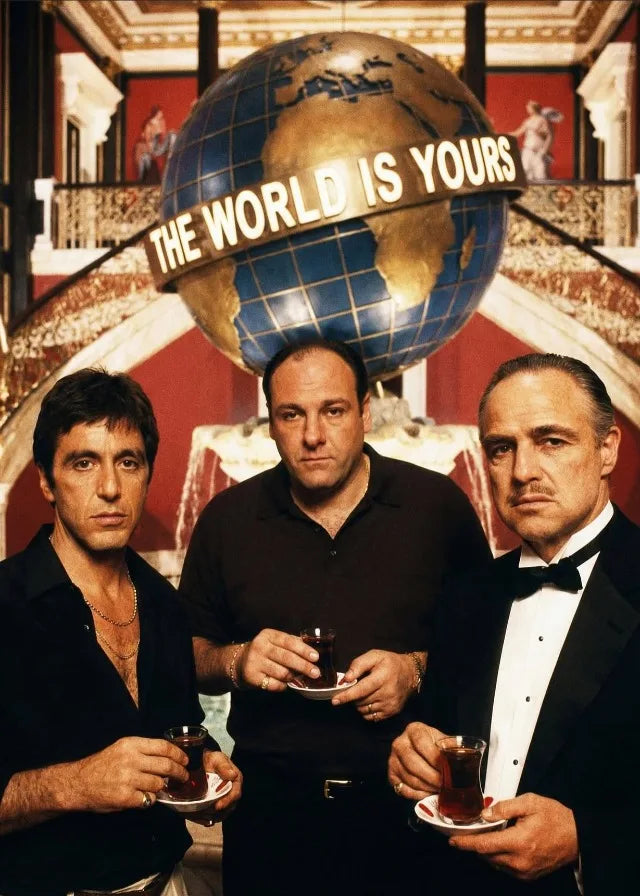 Three men pose in front of a large globe with the text The World Is Yours, featuring a canvas wall art style.