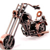 A handcrafted metal motorcycle model with copper and black finish displayed against a white background.