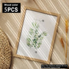 A framed watercolor illustration of a palm leaf on a light wooden frame set of five.