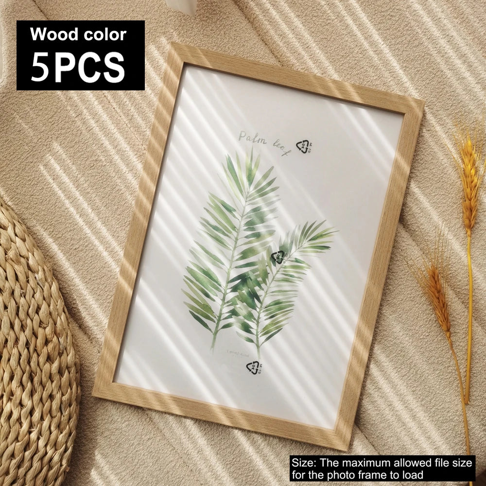 A framed watercolor illustration of a palm leaf on a light wooden frame set of five.
