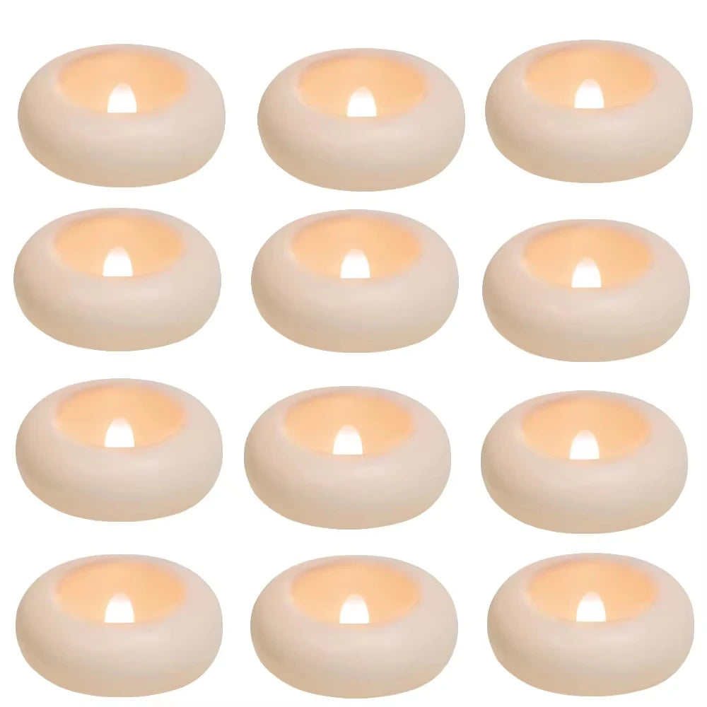 A set of eight round, white floating LED candles with a warm white glow.
