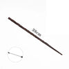 A long, dark brown metal magic wand with a pointed tip, shown next to a measurement marker.