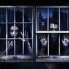 A dark window banner featuring two faces peering through glass, suggesting a scary Halloween theme.