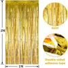 Vertical display of gold metallic tinsel foil fringe curtain backdrop with double-sided adhesive tape.