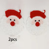 A pair of handmade crochet Santa Claus coasters featuring red and white yarn details.