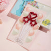 A set of 24 gradient blue metallic birthday candles in a clear plastic packaging with pink and white wax melts.
