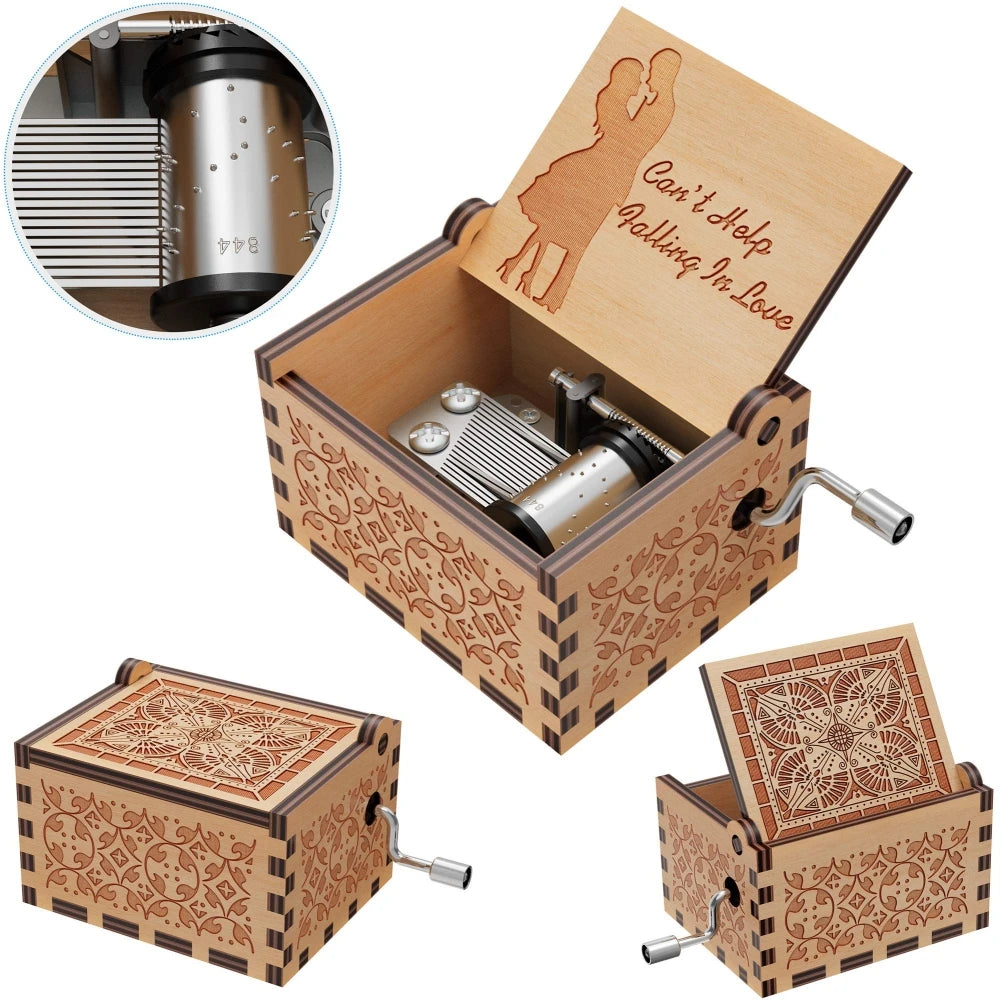 A vintage hand-cranked wooden music box with an ornate lid and decorative carvings, featuring a ballerina silhouette.