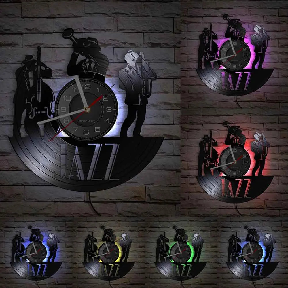 A dark wall display featuring multiple vintage vinyl record-themed clocks and silhouettes against a brick background.