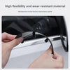 A hand is installing a black carbon fiber rearview mirror rain guard onto a car's side mirror.