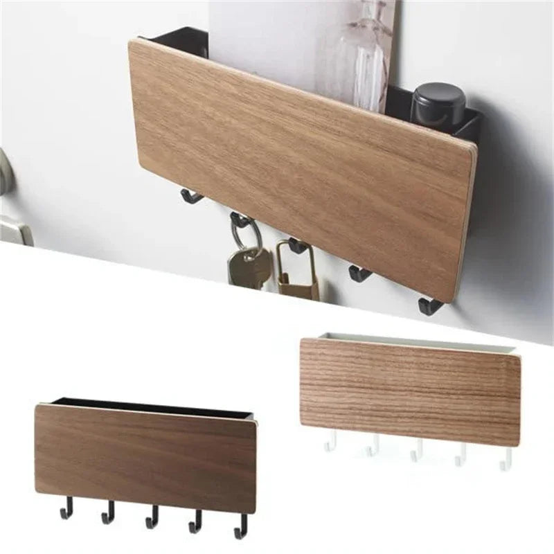 A wooden wall-mounted key rack with six hooks is shown mounted on a white surface.