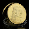 A close-up of a gold-plated commemorative coin featuring a profile portrait of Jesus Christ.