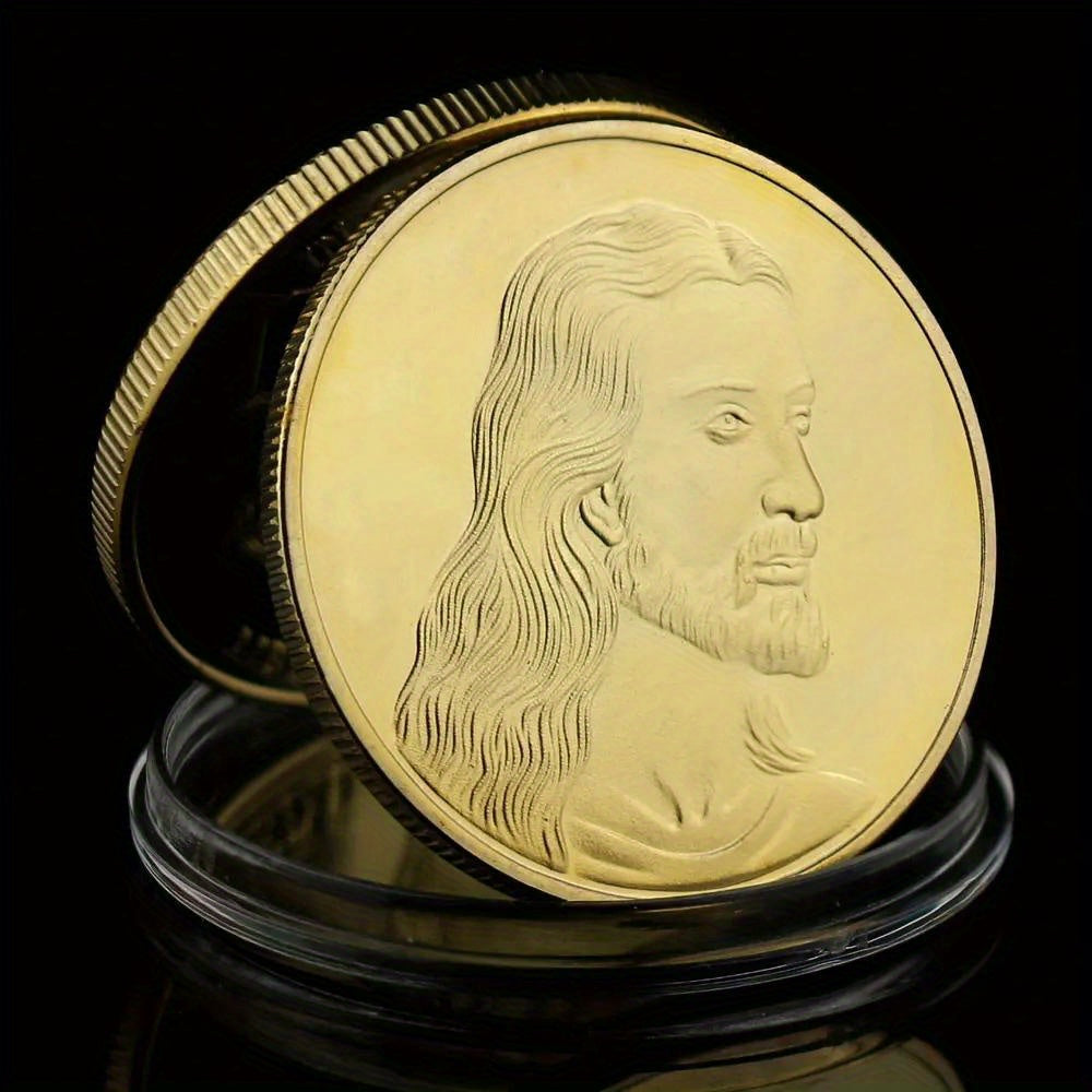 A close-up of a gold-plated commemorative coin featuring a profile portrait of Jesus Christ.