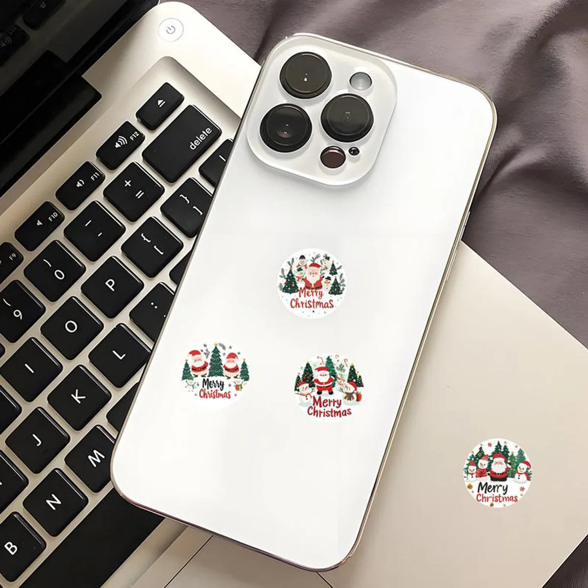 A white Apple Pencil case features festive Christmas wreath stickers for gift wrapping and card decoration.