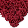 A dense cluster of deep red artificial foam roses.