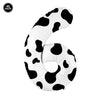 A white cow print number foil balloon shaped like the number 6, used for farm-themed parties.