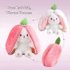 A white bunny plush toy with pink strawberry ears and a pink strawberry shaped fabric.